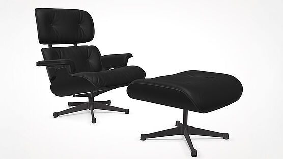 Der Vitra Lounge Chair mit Ottoman in Kastanie schwarz lackiert mit Premium Leder nero ist bei Grünbeck Einrichtungen zu einem Sonderpreis lagernd und sofort verfügbar