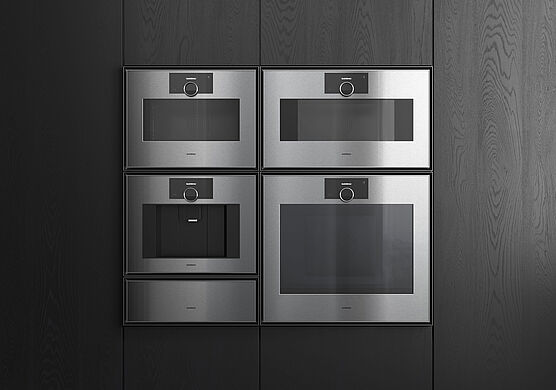 The new Gaggenau Expressive Series, featuring an oven, steam oven, warming drawer, vacuum sealer drawer, and fully automatic coffee machine, is on display and available at Grünbeck Einrichtungen Vienna