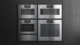 The new Gaggenau Expressive Series, featuring an oven, steam oven, warming drawer, vacuum sealer drawer, and fully automatic coffee machine, is on display and available at Grünbeck Einrichtungen Vienna
