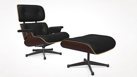 The Vitra Lounge Chair with Ottoman in dark walnut lacquer with premium nero leather is in stock at Grünbeck Einrichtungen at a special price and available immediately.