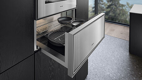 The new Gaggenau Expressive Series, featuring an oven, steam oven, warming drawer, vacuum sealer drawer, and fully automatic coffee machine, is on display and available at Grünbeck Einrichtungen Vienna