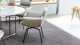 KFF Faye armchair with upholstered armrests KFF presents armchairs with upholstered armrests in a mix of fabric and leather and a cross frame with return mechanism in the elegant Faye product family. Faye is available in many different designs from Grünbeck Einrichtungen.