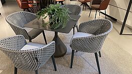 Dedon outdoor seating group with satellite dining table and 4 Mbrace armchairs on sale at Grünbeck interiors Vienna