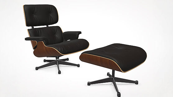 The Vitra Lounge Chair with Ottoman in natural walnut with premium chocolate leather is in stock at Grünbeck Einrichtungen at a special price and available immediately.